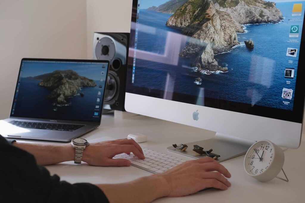 A person working on two Computer.